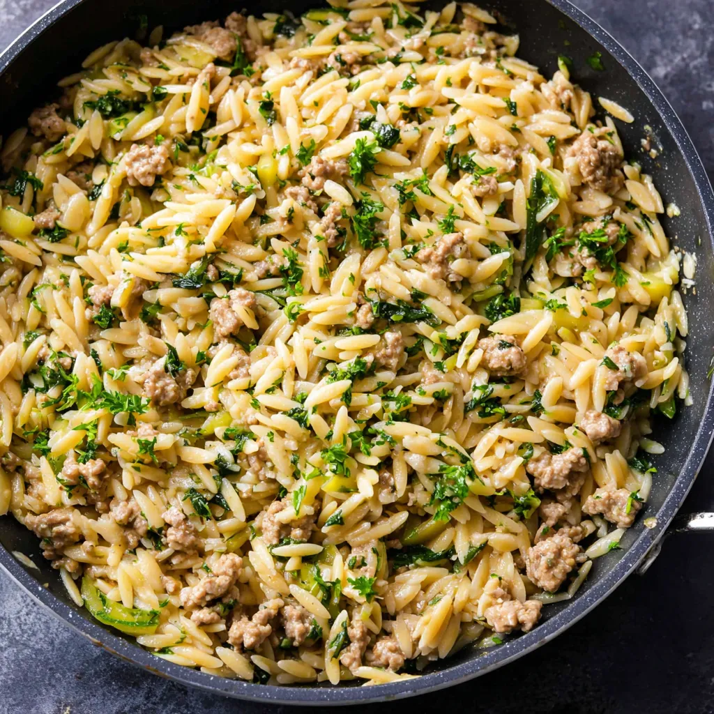 A close-up shot showcases the delicious Ground Turkey Orzo Skillet, highlighting the texture and ingredients of this one-pan meal.